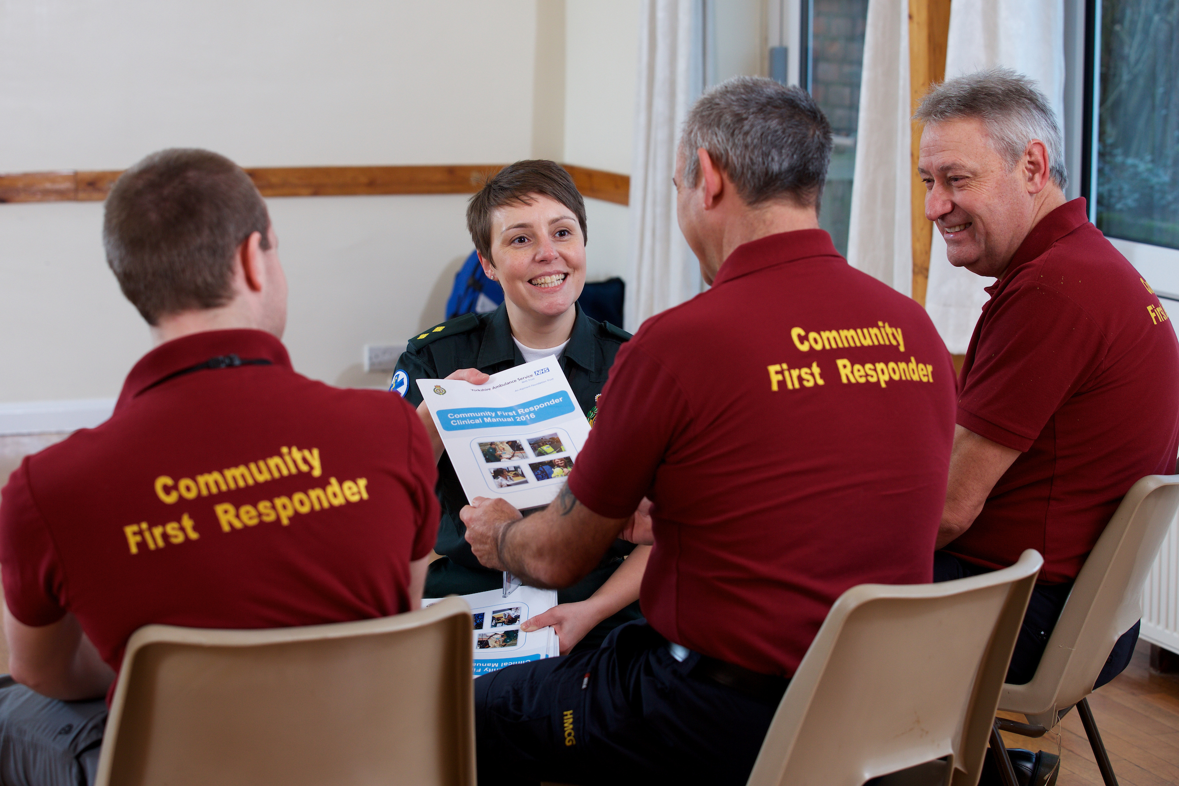 CFR Volunteers receiving training in a classroom from ambulance staff