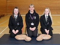 Teacher and pupils posing with resus manikins