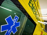 Close-up of an ambulance, the Star of Life is in the foreground.