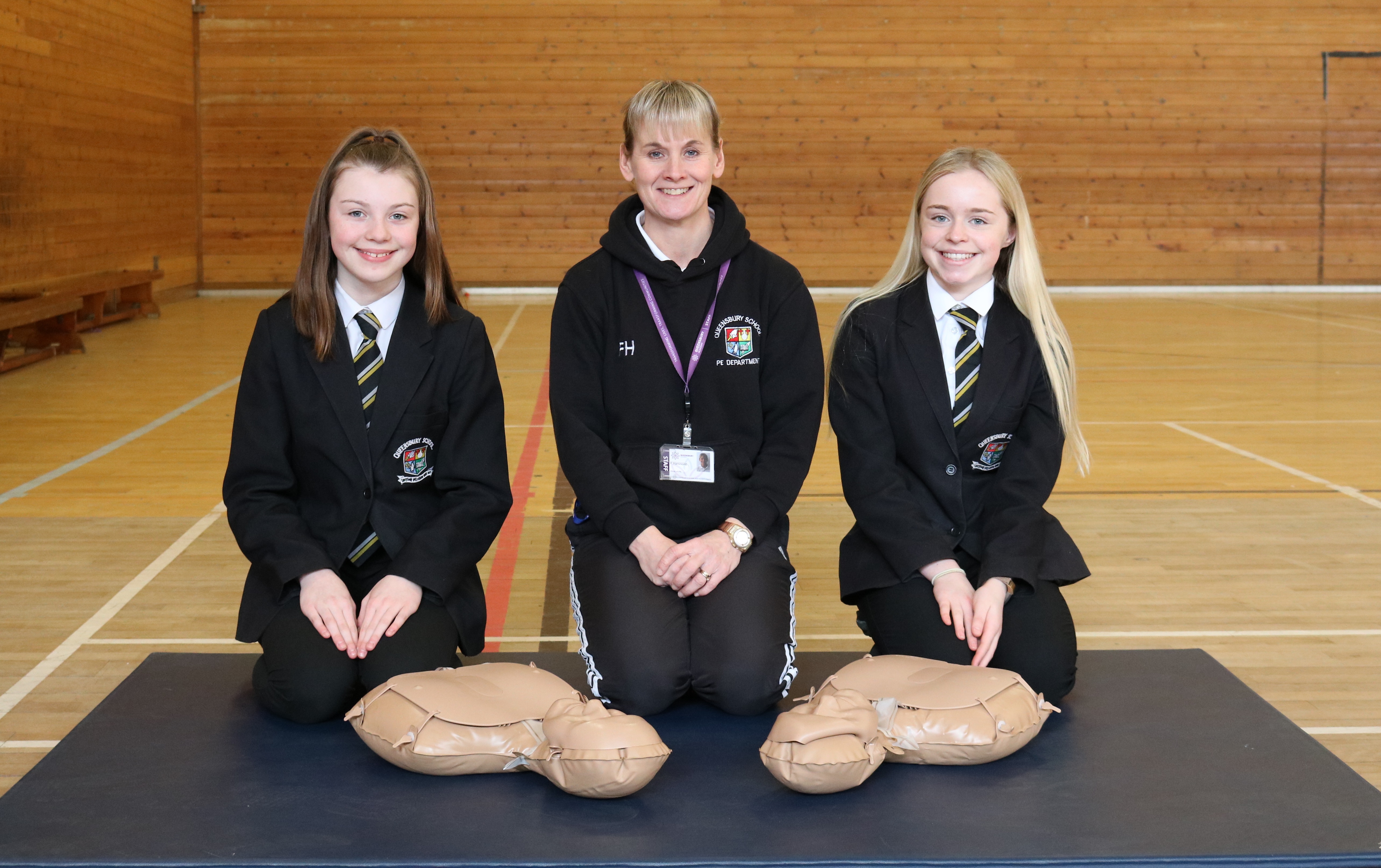 Teacher and pupils posing with resus manikins