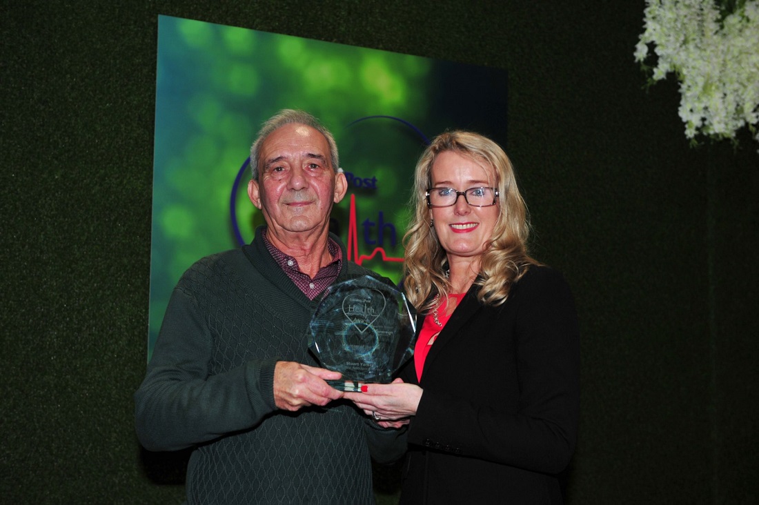 man and woman with award