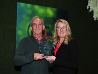 man and woman with award