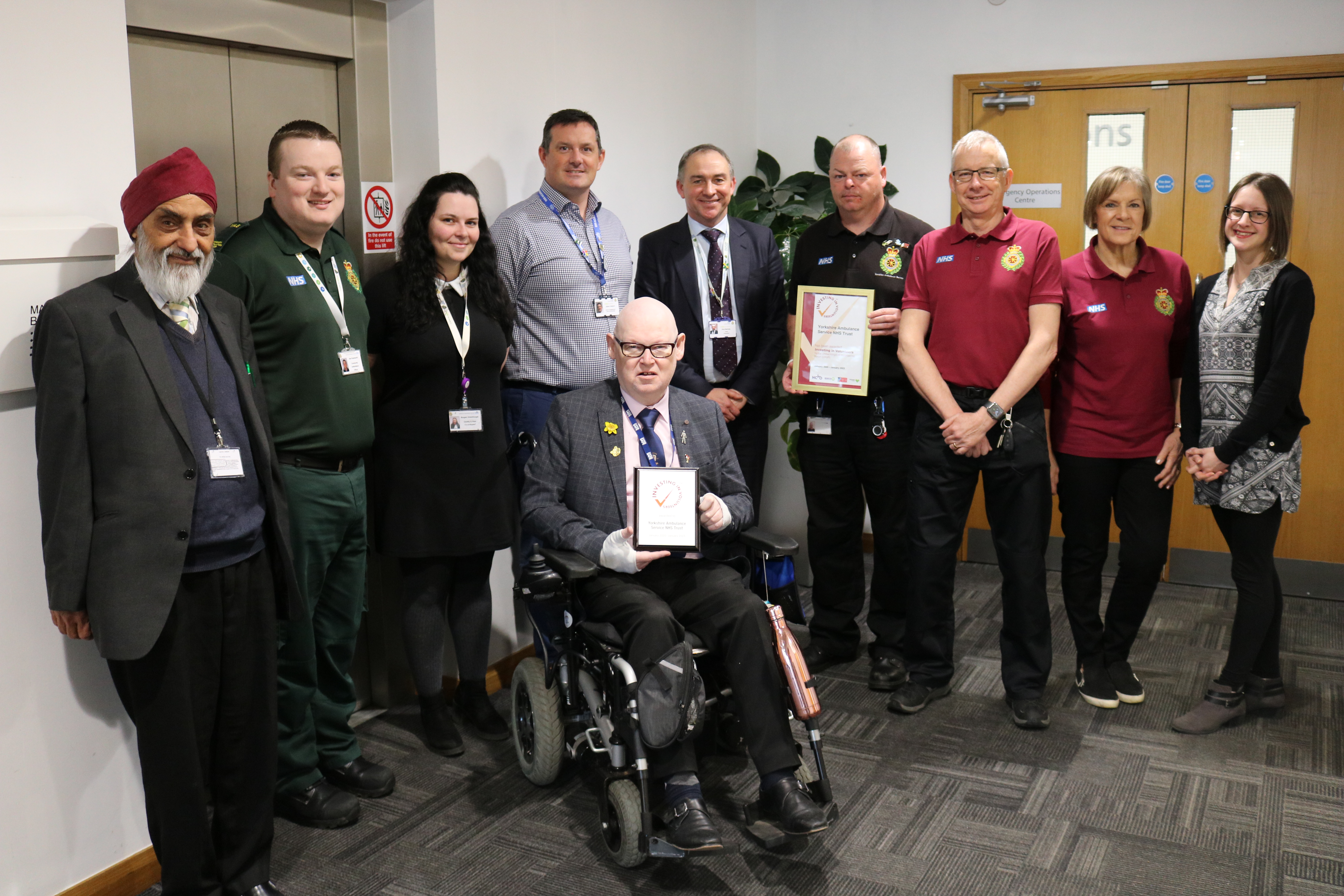 Staff and volunteers celebrate Investing in Volunteers Accreditation