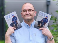 Photographer Rick Corbishley with his book