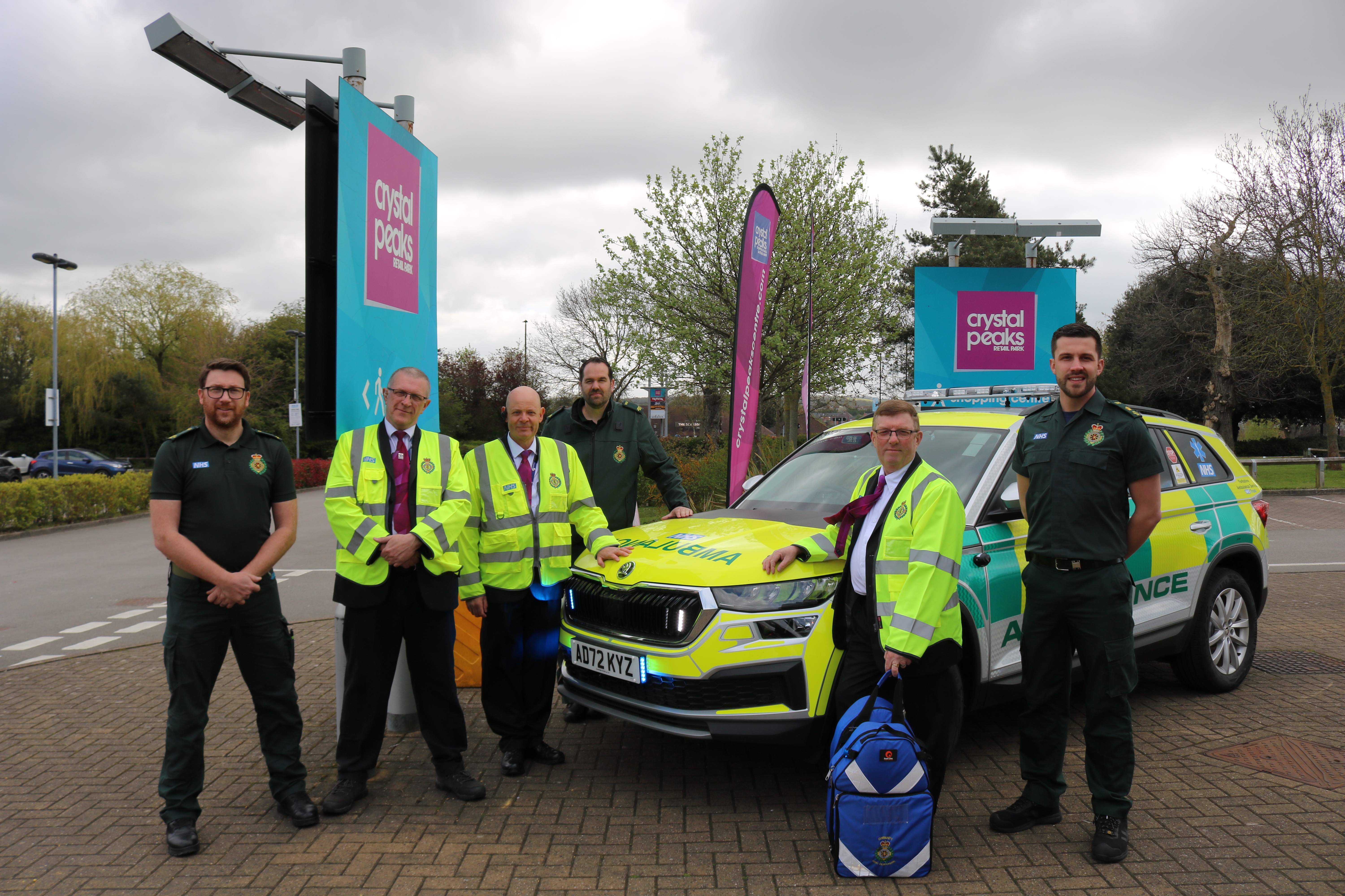 Yorkshire Ambulance Service Staff and Volunteers in uniform, stood with a Rapid Response Vehicle at Crystal Peaks, Sheffield