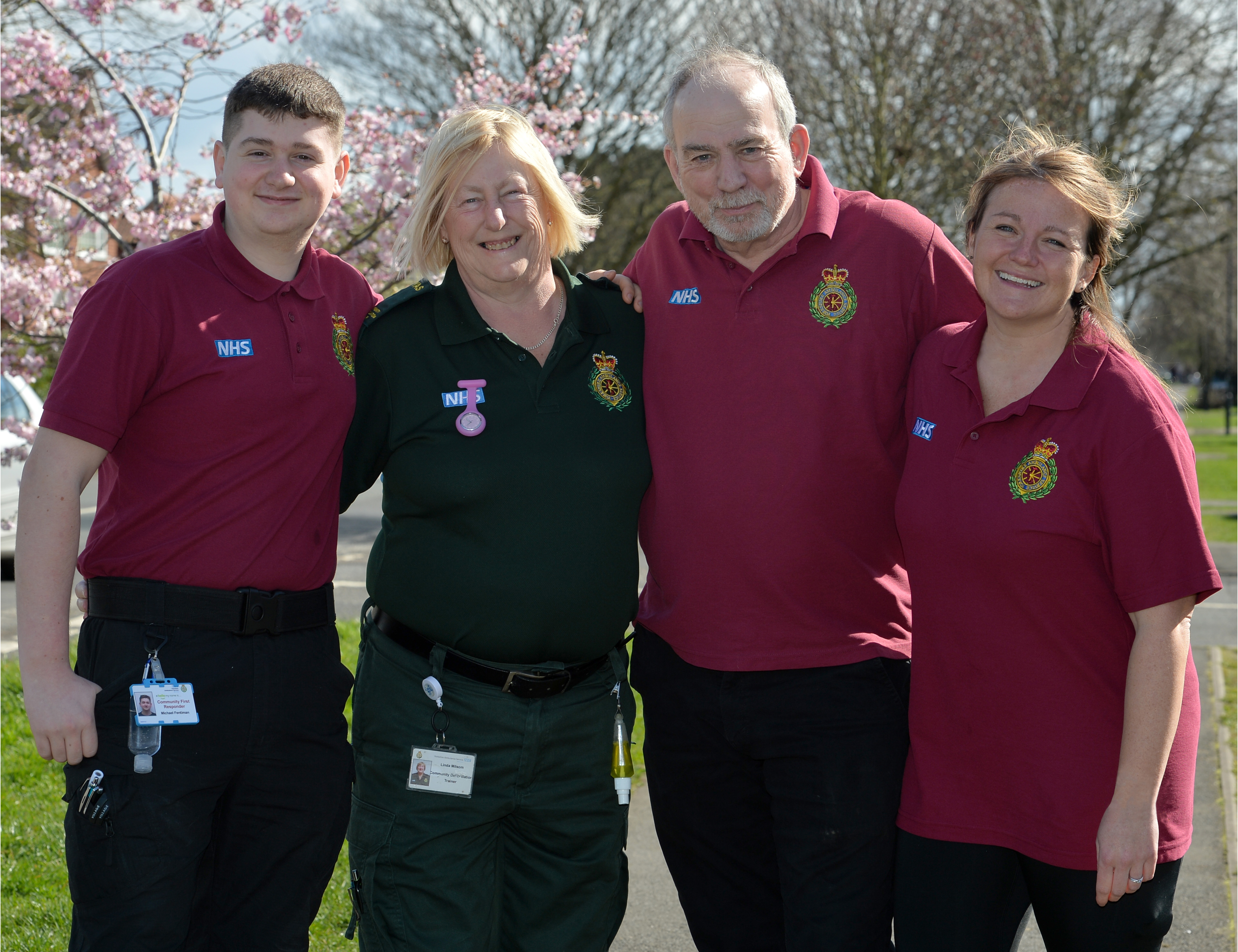 Three Community First Responders, in uniform, and a YAS member of staff