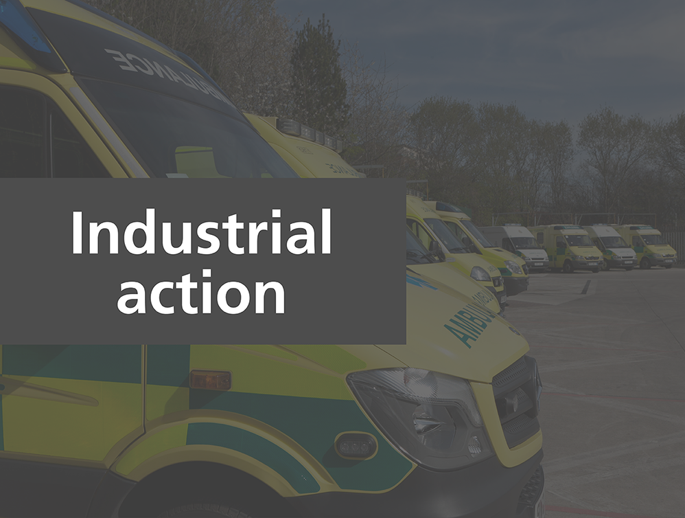 Parked up emergency ambulance vehicles with text overlaid that reads 'Industrial action'