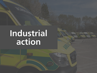 Parked up emergency ambulance vehicles with text overlaid that reads 'Industrial action'