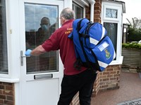 A picture of a person walking carrying a bag