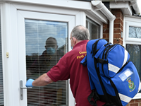 A picture of a person walking carrying a bag