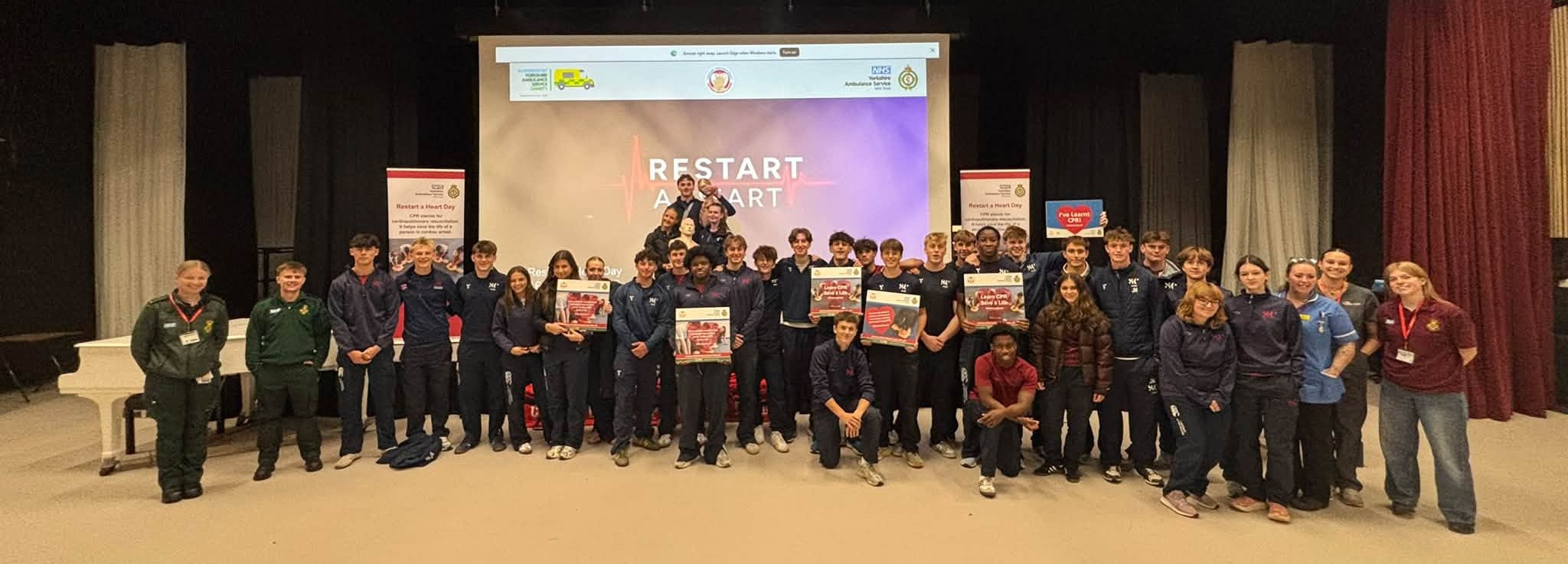 Students learning CPR to mark Restart a Heart Day